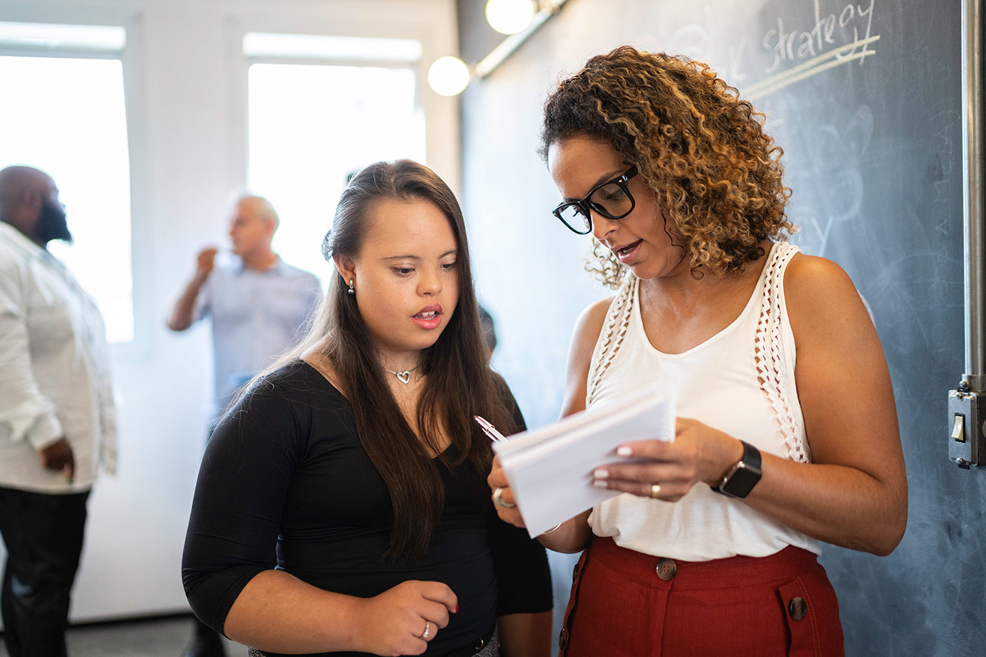 accessibility-2-people-discussing-taking-notes-istock-929216098