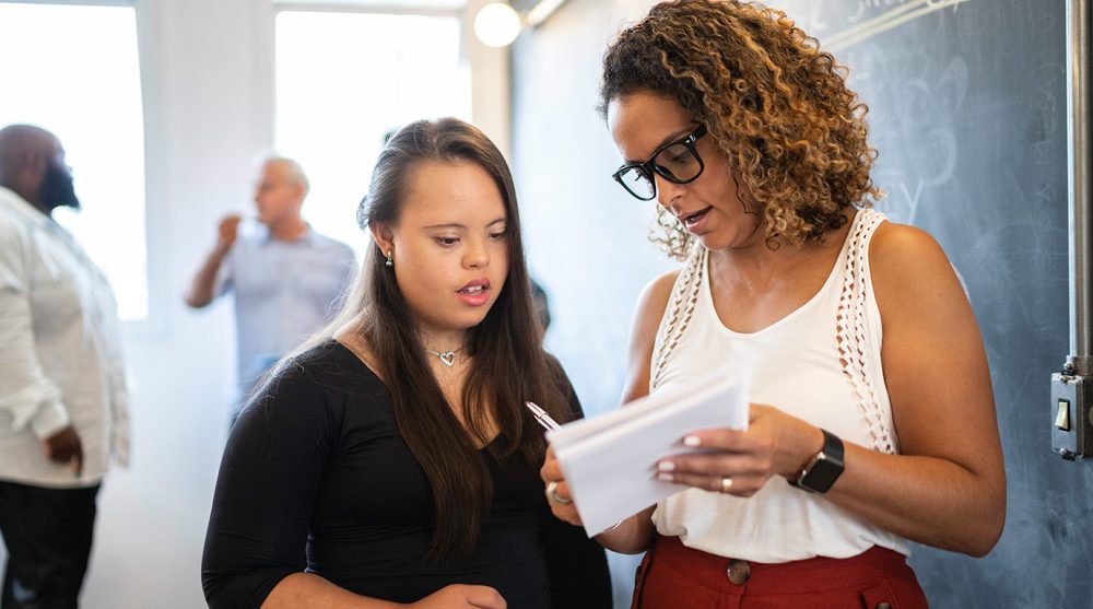 accessibility-2-people-discussing-taking-notes-istock-929216098